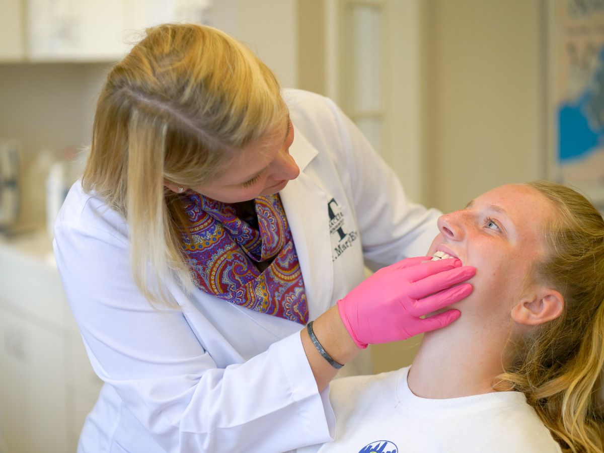Dr. MaryEvan looking at a patient's teeth